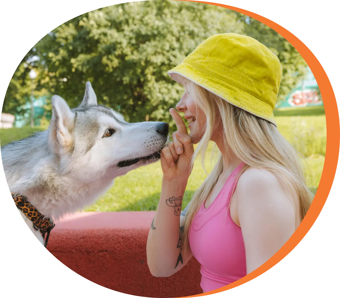 Group 1321314755 A woman and her dog are kissing each other.